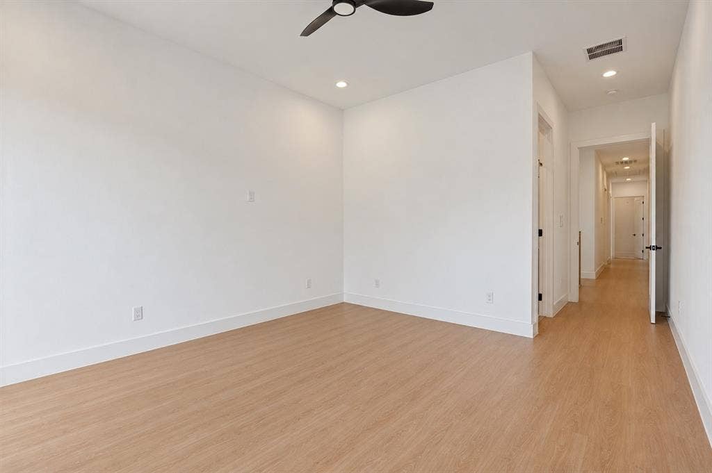 314 Avenue L, Dallas, TX 75203 Wood-finish flooring throughout, white walls, recessed ceiling lighting, and a ceiling fan