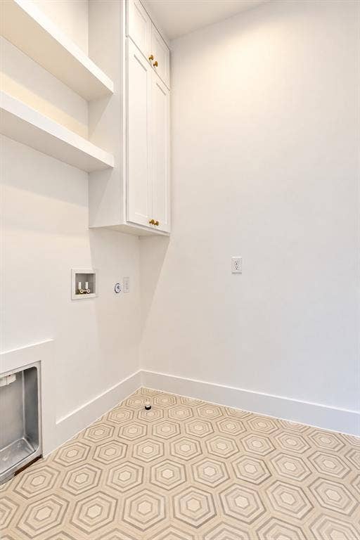 314 Avenue L, Dallas, TX 75203 White cabinetry with gold-tone hardware, floating shelves, and geometric patterned floor tile