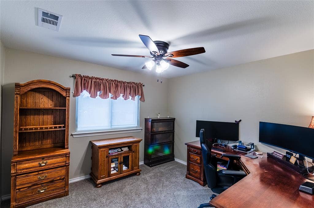 4009 Wilshire Court, Plano, TX 75023 Neutral-toned walls complement the gray carpeting