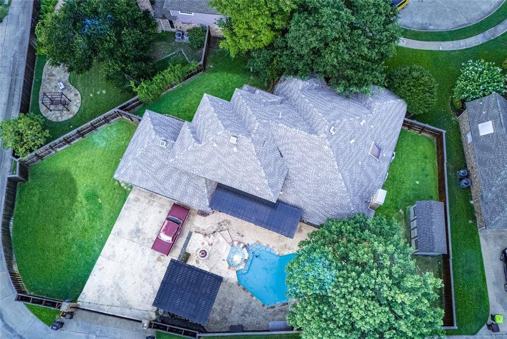 4009 Wilshire Court, Plano, TX 75023 Expansive concrete patio area featuring a swimming pool with a spa, a fire pit, and an attached covered patio