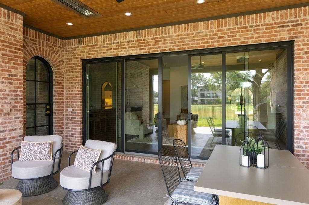 3368 Dorado Beach Drive, Farmers Branch, TX 75234 Brick exterior with wood-finish ceiling, recessed lighting, and an arched black-framed door