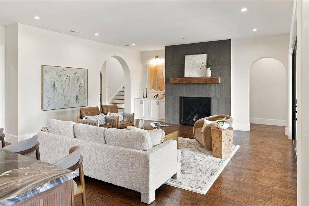 3368 Dorado Beach Drive, Farmers Branch, TX 75234 Recessed lighting, wood-finish flooring, arched doorways, a built-in fireplace with a stone surround, and a wood mantel