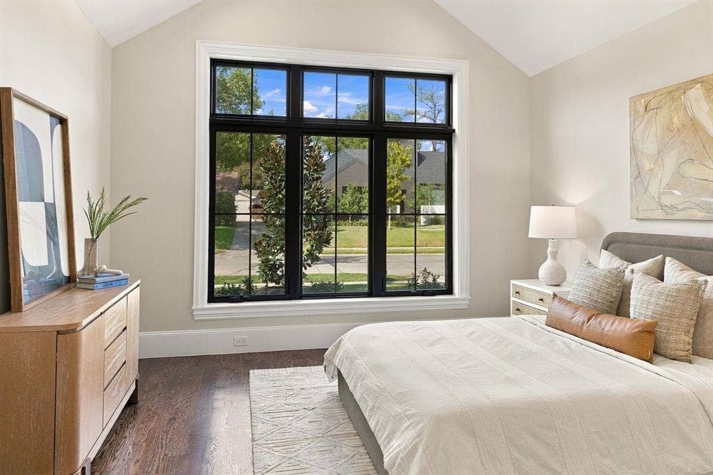 3368 Dorado Beach Drive, Farmers Branch, TX 75234 Vaulted ceiling, large multi-pane window with dark trim, hardwood flooring, and light-toned walls