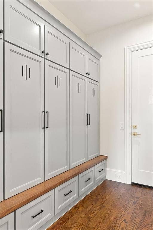 3368 Dorado Beach Drive, Farmers Branch, TX 75234 Built-in cabinetry with light gray shaker-style doors, black hardware, an integrated wood-finish bench, and wood-finish flooring