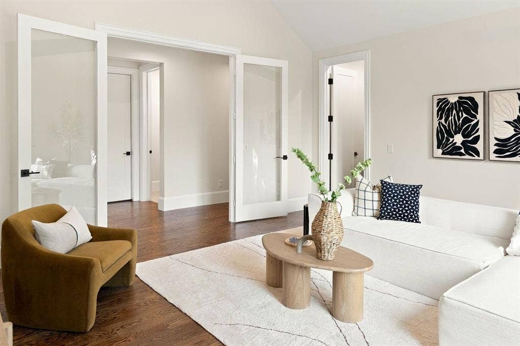 3368 Dorado Beach Drive, Farmers Branch, TX 75234 Rich wood-finish flooring, vaulted ceiling, and dual glass-panel doors with matte black hardware