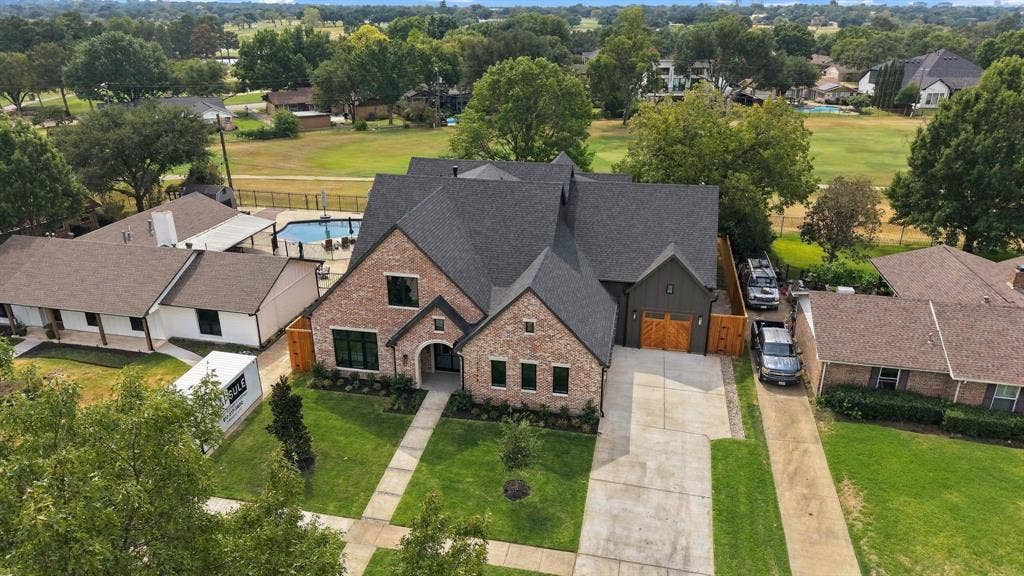 3368 Dorado Beach Drive, Farmers Branch, TX 75234 Brick and dark siding exterior with arched entry