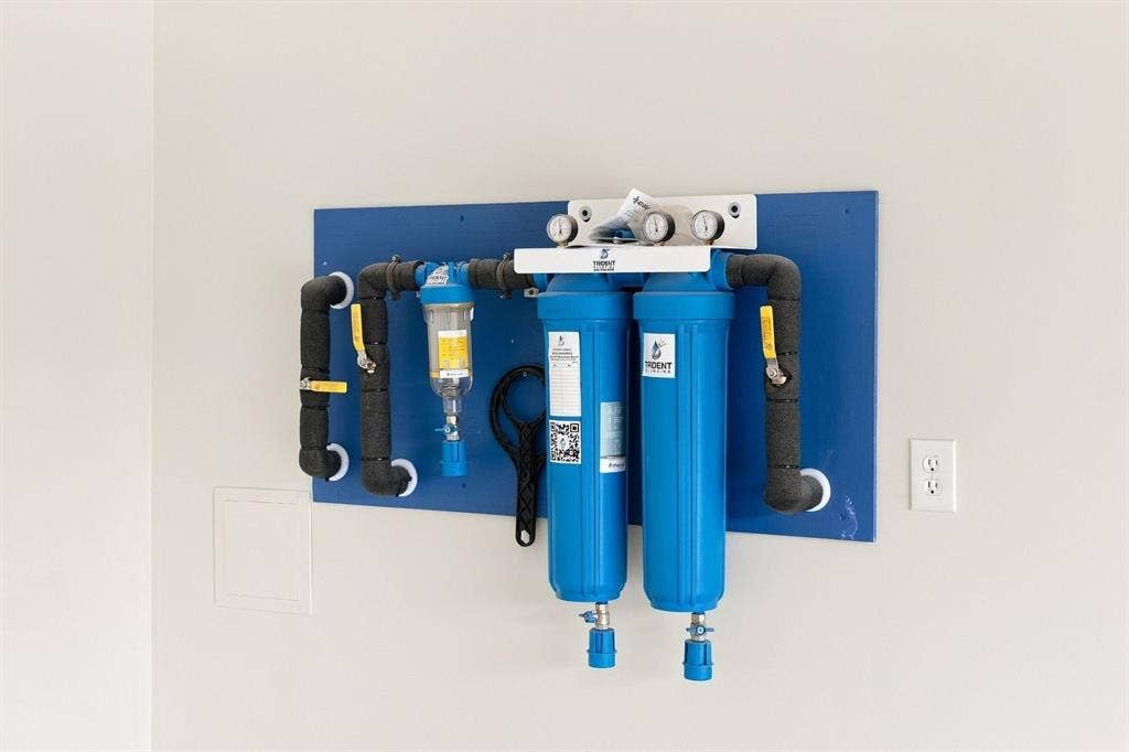 3368 Dorado Beach Drive, Farmers Branch, TX 75234 Wall-mounted water filtration system with insulated piping and pressure gauges