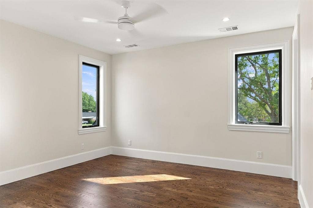 3368 Dorado Beach Drive, Farmers Branch, TX 75234 Hardwood flooring, recessed lighting, ceiling fan, and two large windows with white trim