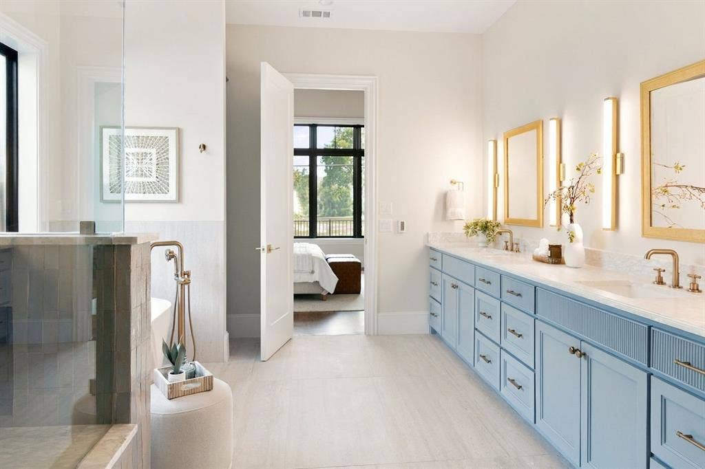 3368 Dorado Beach Drive, Farmers Branch, TX 75234 Dual vanity with light blue cabinetry, quartz countertops, and gold-framed mirrors
