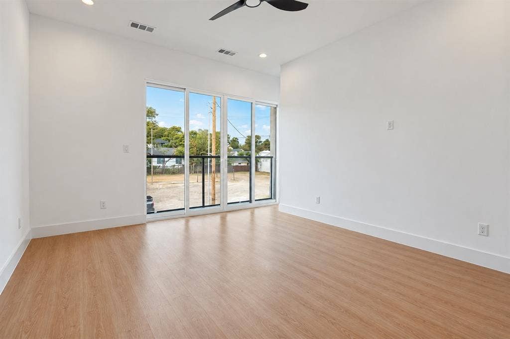 316 Avenue L, Dallas, TX 75203 Wood-finish flooring with white walls and a ceiling fan