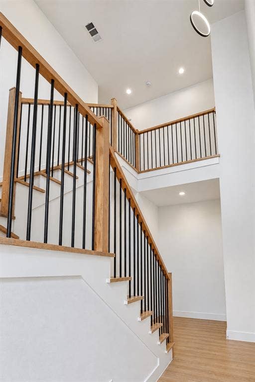 314 & 316 Avenue L, Dallas, TX 75203 Two-story entryway featuring wood-finish flooring, a staircase with wood-finish handrails, and black metal balusters