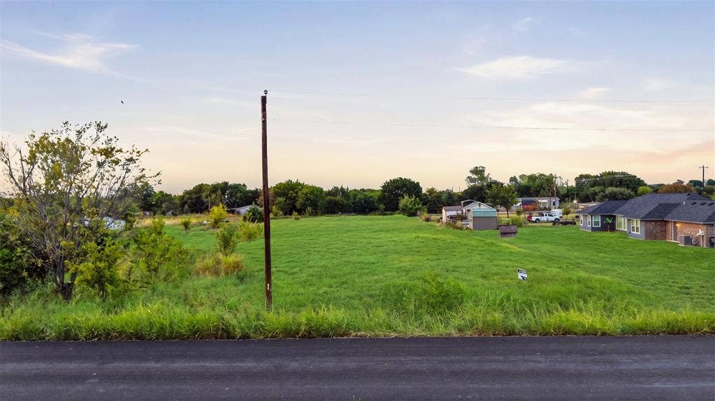 000 CR-760, Nevada, TX 75173 Expansive green field with natural ground cover, offering a spacious setting