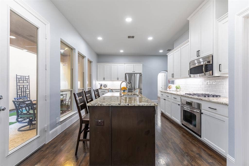 Spacious kitchen with pristine white cabinetry.
