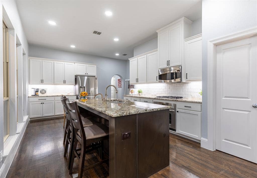 Kitchen features granite countertops and oversized pantry.