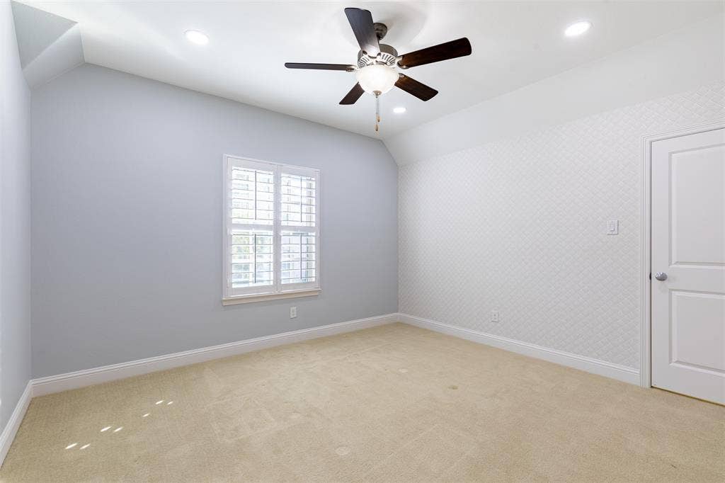Secondary upstairs bedroom with ceiling fan.