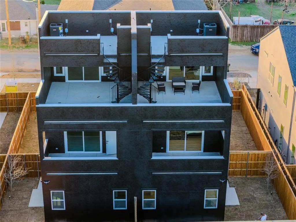 2802 Guymon Street, Dallas, TX 75212 Modern facade with multiple outdoor terraces, spiral staircase access, and private fenced backyards