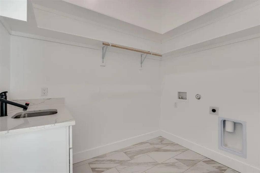 2802 Guymon Street, Dallas, TX 75212 Utility area featuring a built-in sink with a matte black faucet, a light-toned countertop, and patterned floor tiling