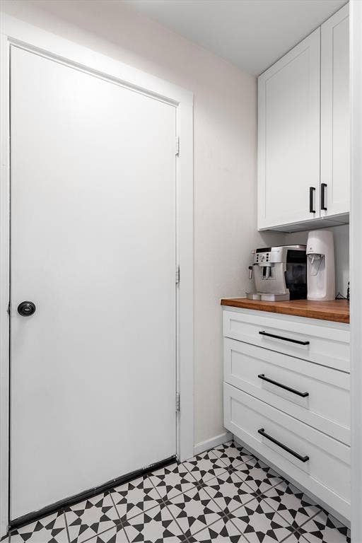 Laundry room has extra storage and counter space.