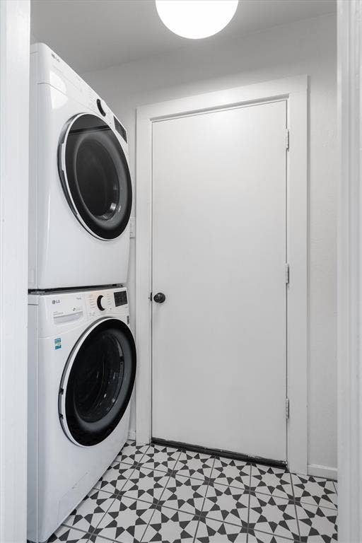 Laundry room with a stacked washer and dryer included in rent.