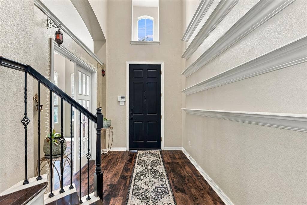 1905 Canyon Wren Drive, McKinney, TX 75071 Two-story entryway featuring high ceilings, wood-style flooring, and a wrought iron staircase