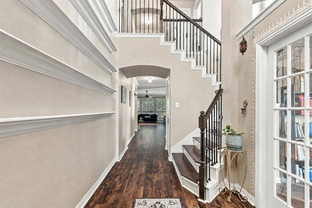 1905 Canyon Wren Drive, McKinney, TX 75071 Two-story entryway featuring high ceilings, wood-style flooring, and a wrought iron staircase