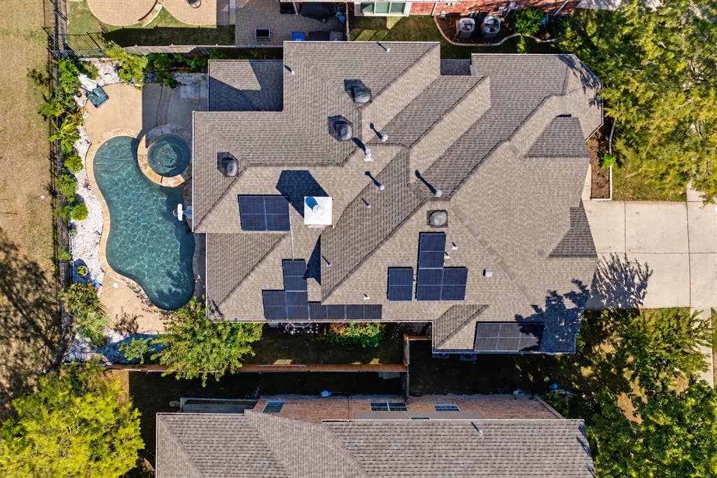 1905 Canyon Wren Drive, McKinney, TX 75071 Solar system with 14 solar panels. Photo taken right after a few days of heavy thunderstorms and rain while the pool was undergoing maintenance. Water shown in the pool and spa has been digitally added.