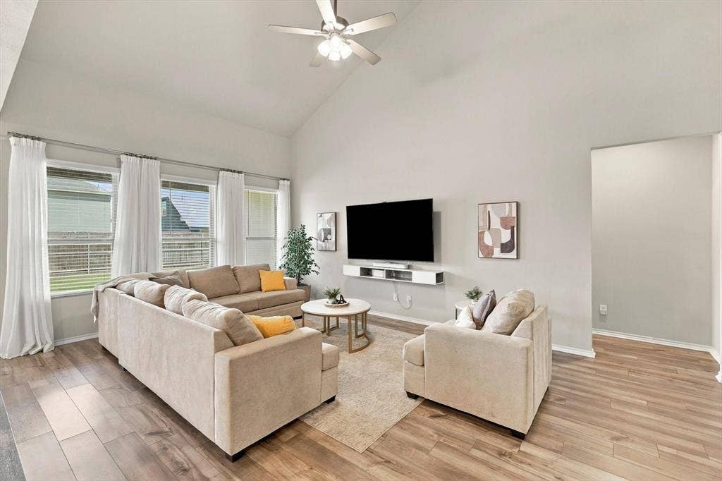 6304 Jib Court, Fort Worth, TX 76179 Vaulted ceiling, ceiling fan, wood-finish flooring, multiple windows, wall-mounted media console