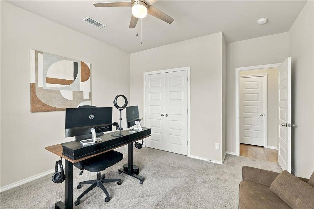6304 Jib Court, Fort Worth, TX 76179 Neutral wall tones with carpet flooring and a ceiling fan