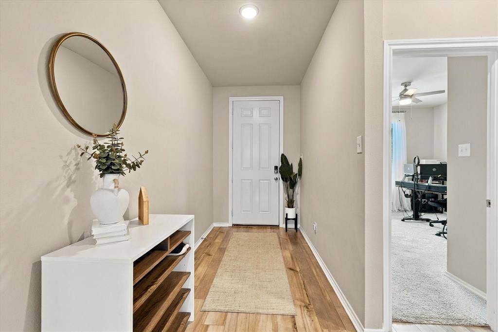 6304 Jib Court, Fort Worth, TX 76179 Recessed ceiling lighting, wood-finish flooring, light neutral wall tones, white interior door with paneling, and an open doorway to another room