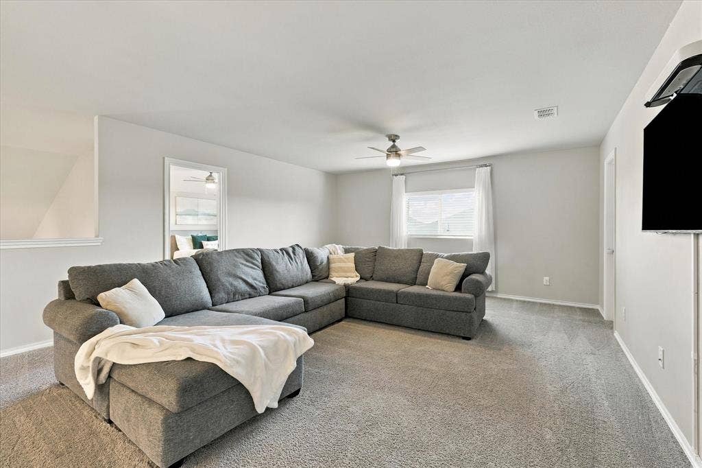 6304 Jib Court, Fort Worth, TX 76179 Carpeted flooring, ceiling fan, white window treatments, and light-colored walls