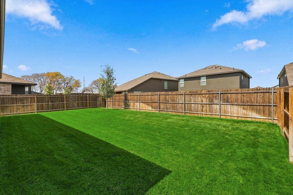 6304 Jib Court, Fort Worth, TX 76179 Expansive green lawn, wood privacy fencing, and a small tree