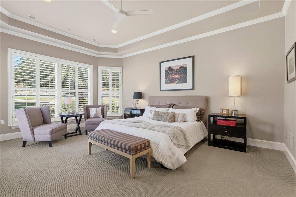 5600 Southern Hills Drive, Frisco, TX 75034 The secluded primary suite offers a tranquil retreat, with a layered tray ceiling, sitting area and picturesque outlook across the green.