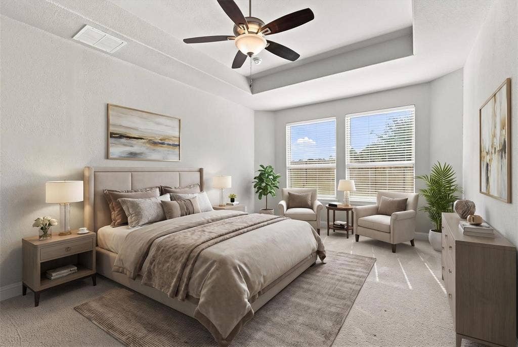 Bright primary bedroom featuring a coffered ceiling, and ample space for a sitting area. (virtually staged photo)