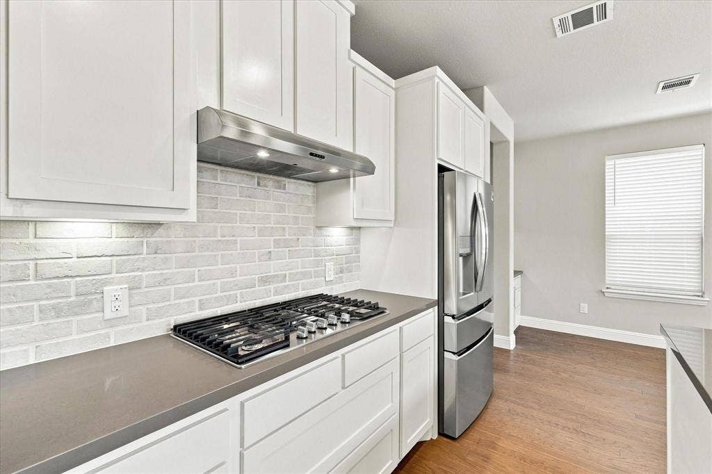Stainless steel gas range, with extra storage.
