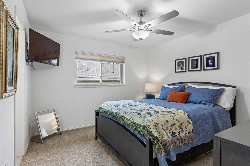 Comfortable Secondary Bedroom — This well-proportioned bedroom includes updated carpeting, a ceiling fan, and natural light for a comfortable, adaptable space.