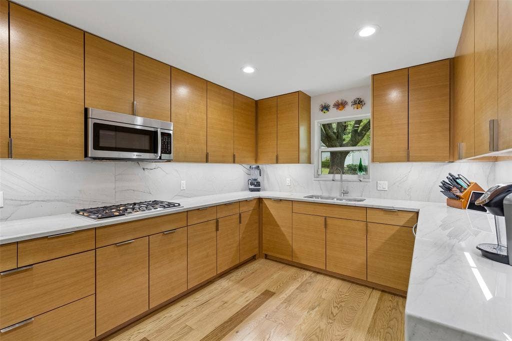Bright Prep Space with a View — A window above the sink brings in natural light while the surrounding counters and cabinetry create an efficient cleanup and prep zone.
