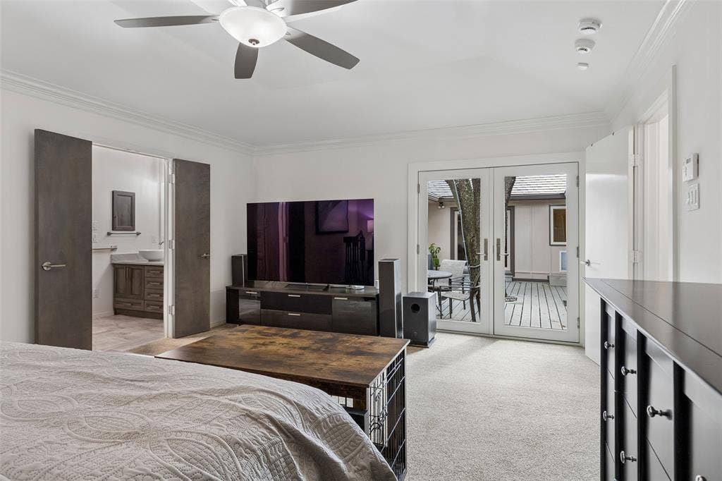 Primary Suite with Courtyard Connection — French doors provide direct access to the courtyard, extending the primary suite outdoors and creating a peaceful spot to step outside with morning coffee or unwind at the end of the day.