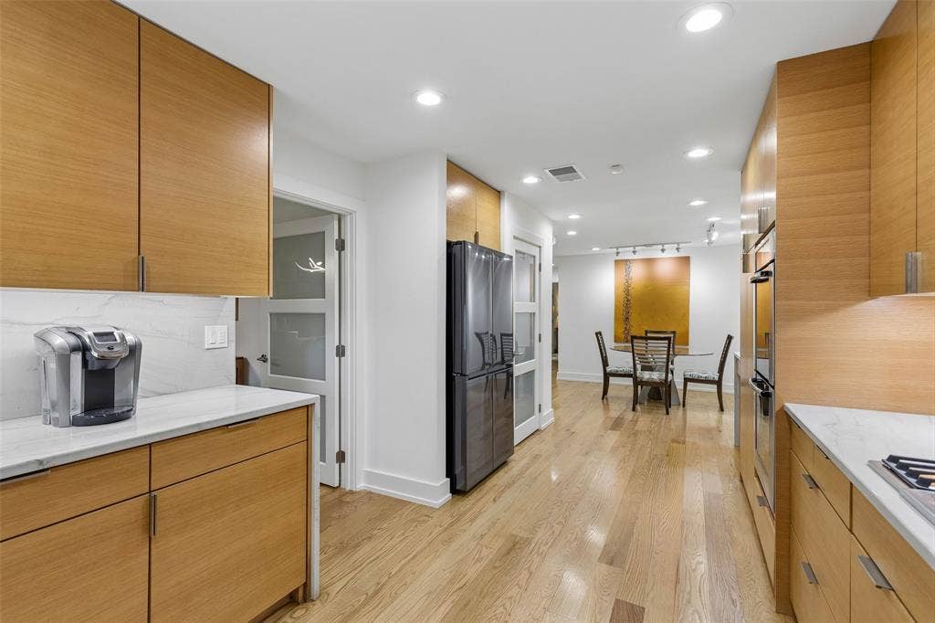 Easy Connection from Kitchen to Dining — This angle highlights the kitchen's direct flow into the casual dining area, making meals, conversation, and entertaining feel naturally connected.