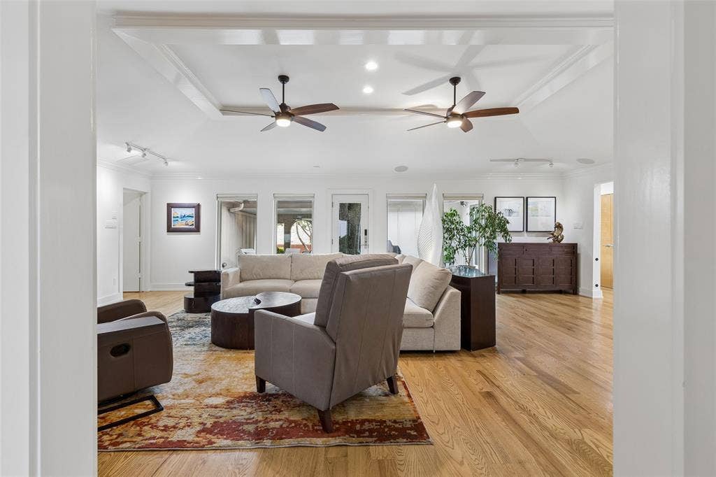 Indoor-Outdoor Connection — A wall of windows and exterior access fill the living area with natural light while creating an easy transition to the backyard and covered outdoor living spaces.