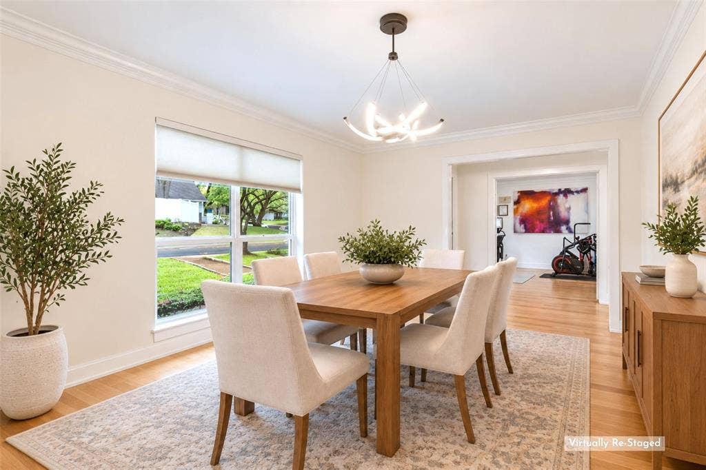Bright, Flexible Dining Space — A large front-facing window brings natural light into the dining room, while the wide opening to adjoining living space keeps the floor plan connected without sacrificing room definition.