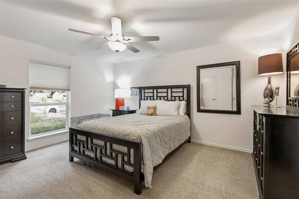 Spacious Third Bedroom - This well-proportioned bedroom offers updated carpeting, a ceiling fan, and a large window that brings in natural light while leaving plenty of room for everyday comfort.