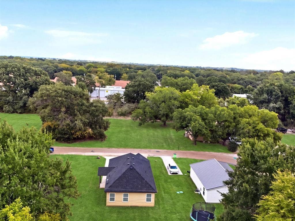 105 Oak Ridge Road, Mabank, TX 75156 Gable roofline, light yellow exterior siding, and a paved driveway