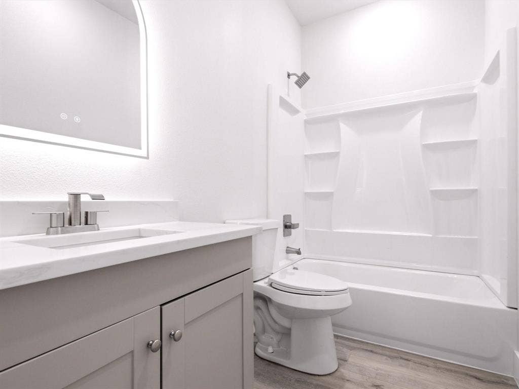 105 Oak Ridge Road, Mabank, TX 75156 Bathroom featuring a light gray vanity with a white countertop, undermount sink, and brushed nickel faucet