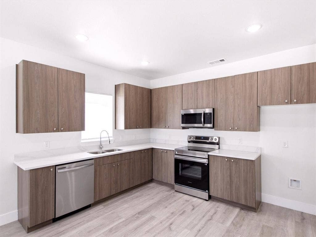105 Oak Ridge Road, Mabank, TX 75156 Kitchen featuring wood-finish cabinetry, white countertops, a stainless steel dishwasher, a stainless steel range, and a stainless steel microwave