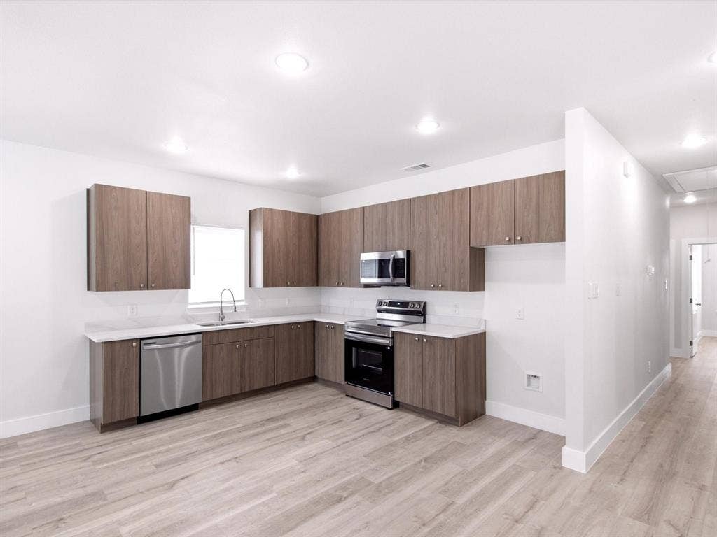 105 Oak Ridge Road, Mabank, TX 75156 Kitchen with wood-finish cabinetry, white countertops, subway tile backsplash, and stainless steel appliances