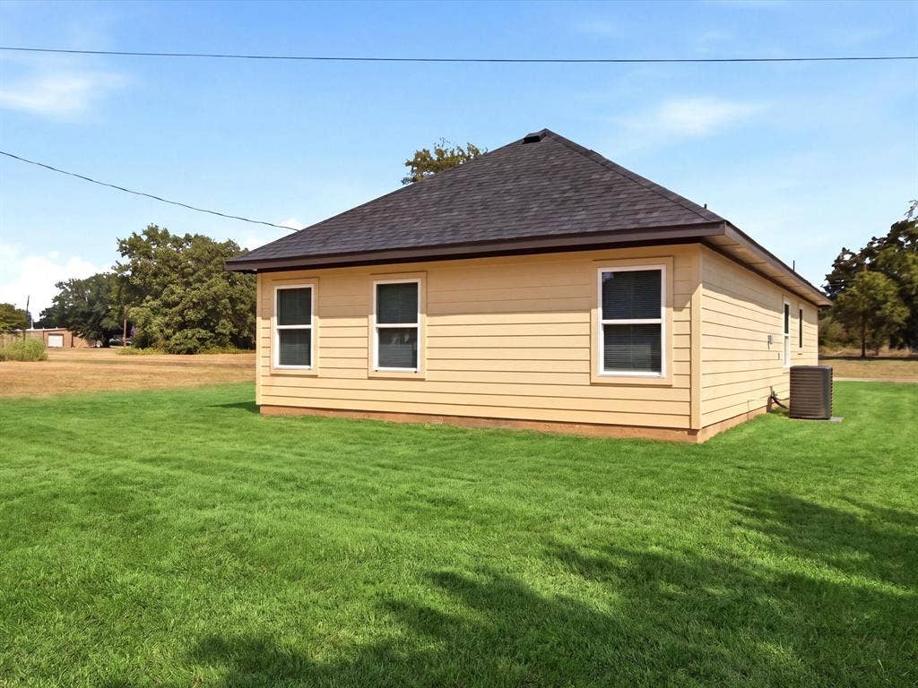105 Oak Ridge Road, Mabank, TX 75156 Exterior featuring horizontal siding, multiple windows with white trim, a dark shingle roof, and a visible HVAC unit