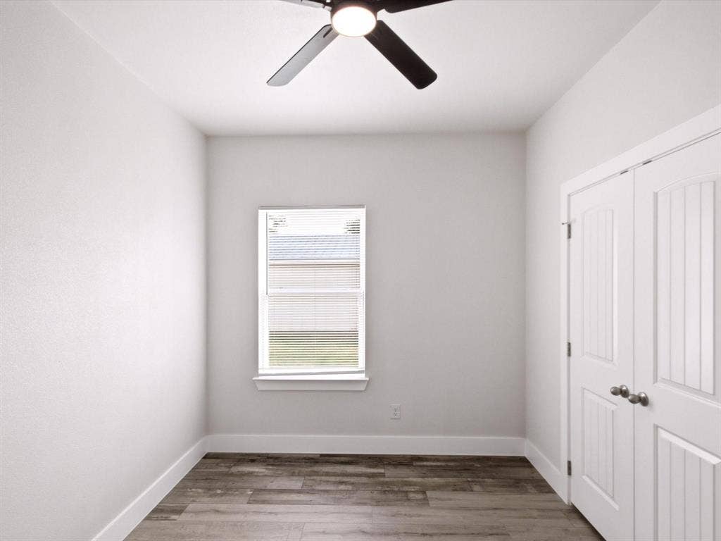 105 Oak Ridge Road, Mabank, TX 75156 Wood-finish flooring, white walls, and a window with blinds
