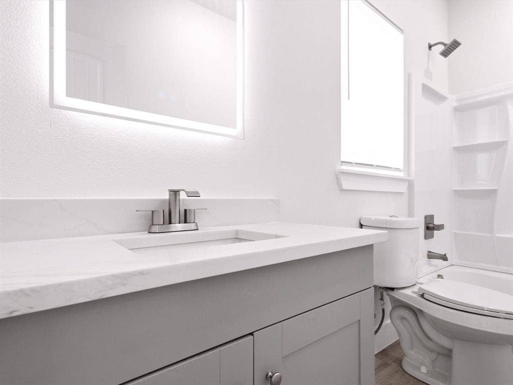 105 Oak Ridge Road, Mabank, TX 75156 Vanity with gray cabinetry, integrated sink, and brushed nickel faucet