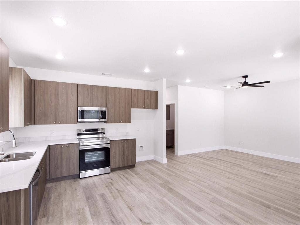 105 Oak Ridge Road, Mabank, TX 75156 Modern kitchen with wood-finish cabinetry and stainless steel appliances