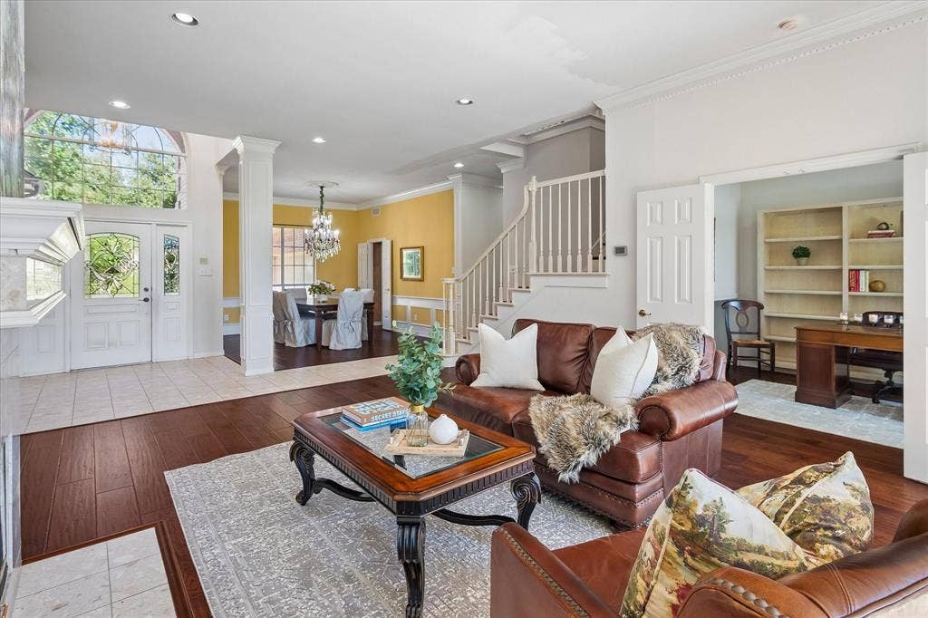 2204 Creekside Circle S, Irving, TX 75063 Terrazzo tile and American Hickory hardwood flooring throughout, a grand entry with decorative glass doors, a formal dining area with a chandelier, and a dedicated office space with built-in shelving